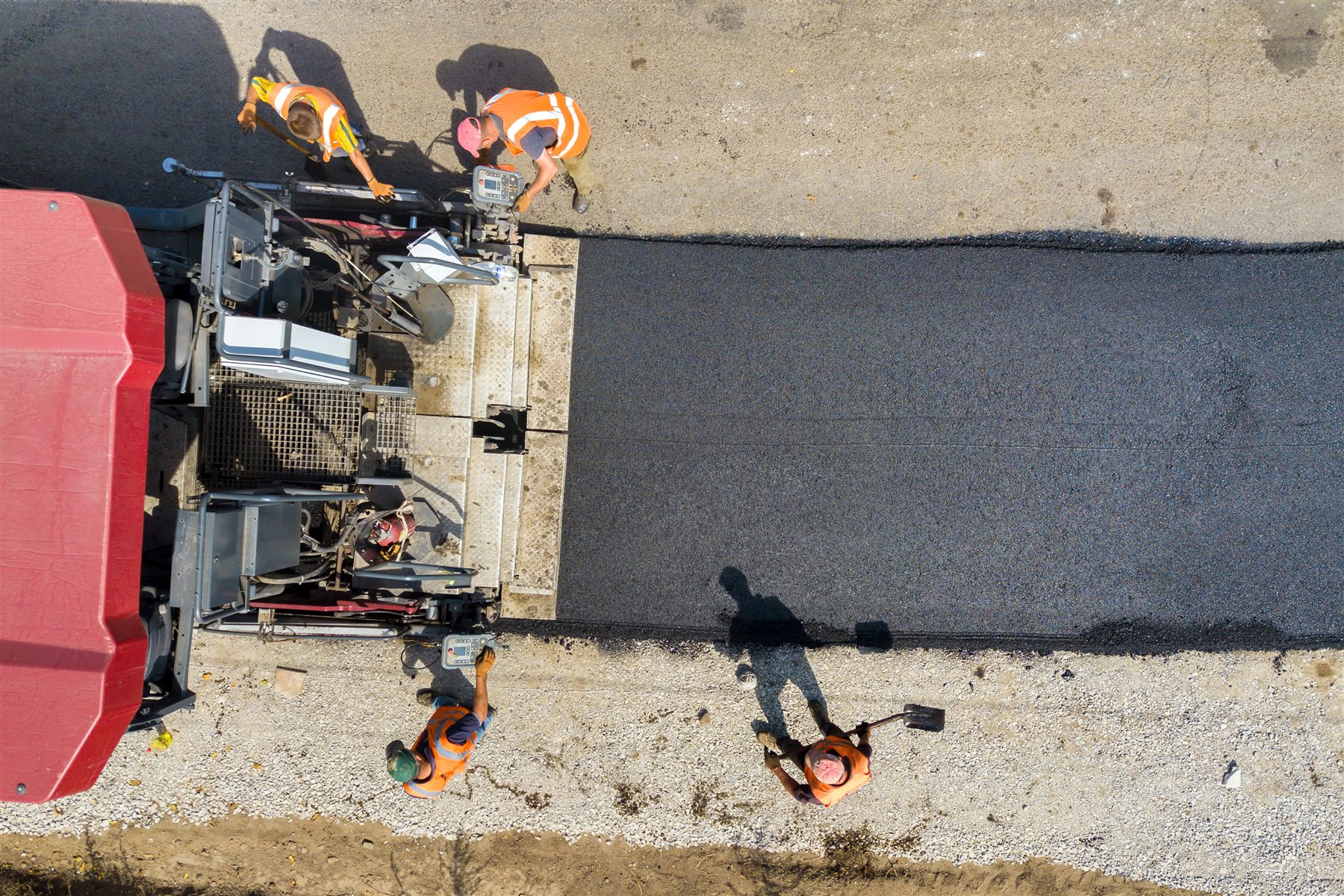 Aerial view of a paving crew installing asphalt